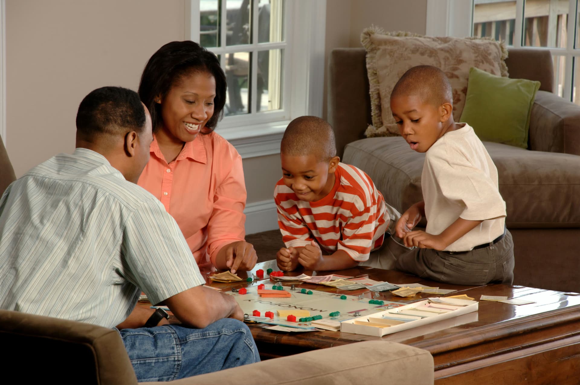 Family playing a board game together in their living room